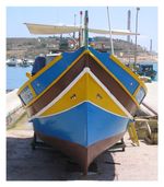 A wooden boat with bright blue and yellow paint sits on a stone dock. The boat has two stylized eyeballs affixed to each side of the bow.
